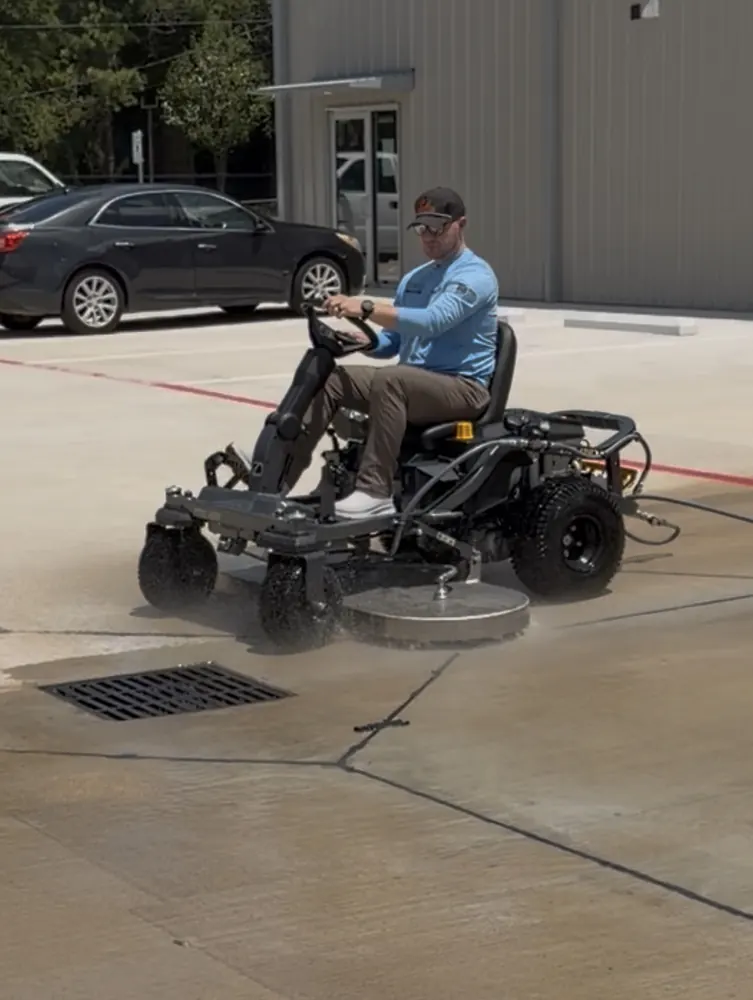 Ward Washing owner operating a ride-on surface cleaner