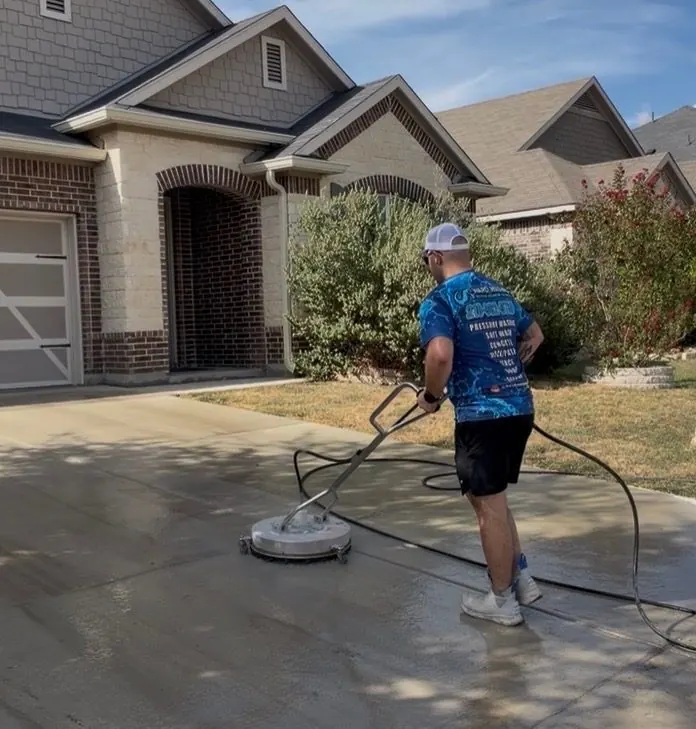Ward Washing owner cleaning a driveway with a surface cleaner